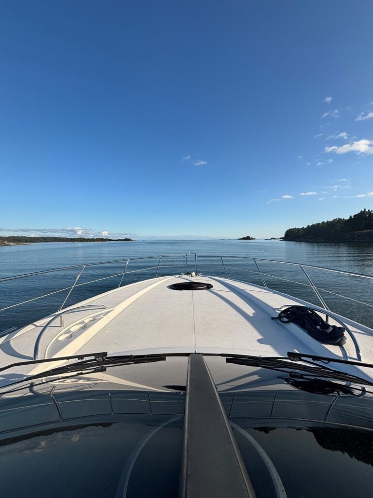 A view across the Pokerface foredeck toward the sunlit archipelago