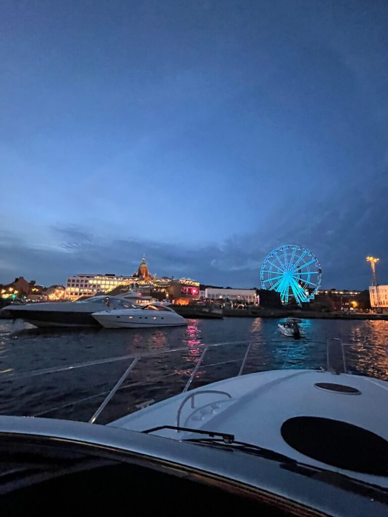 Helsinki harbour and the illuminated Ferris wheel from the yacht
